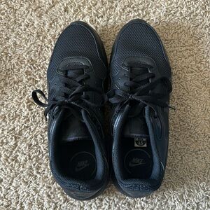 All black Nike shoes
